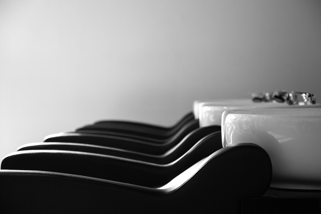 about-01 a-row-of-black-and-white-chairs-next-to-a-sink-k5xtu6dapuk